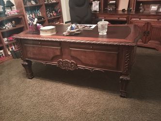 I\nHave an executive desk , quite large , solid oak wood , very heavy cabins behind it for your computer and all your storage and a nice chair