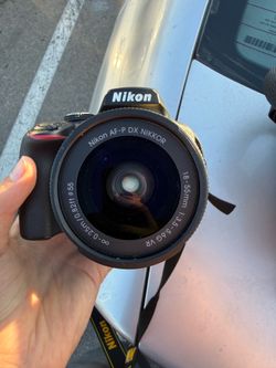 Nikon D3400 camera with carry bag, extra lens, and battery charger