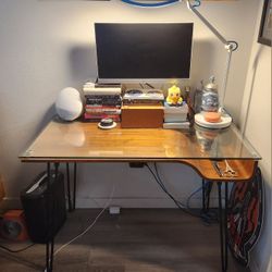 Modern glass top desk, green bungee office chair, and 23" monitor