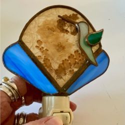 Stained glass hummingbird nightlight is in excellent condition, works well, comes with the bulb, on off switch. Hummingbird is raised, 3D center secti
