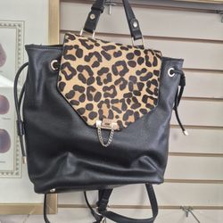 Dune London black leather backpack with a genuine calf hair leopard print flap