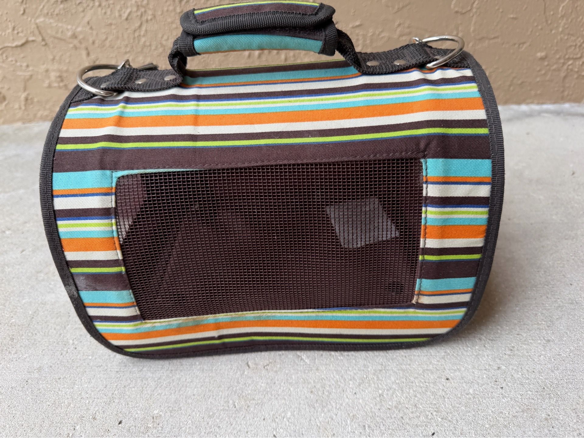 Soft-sided pet carrier featuring multi-colored stripes and mesh ventilation, size XS
