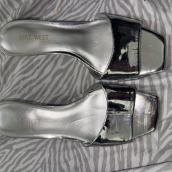 Nine West Oklee platform slide sandals in a metallic silver
