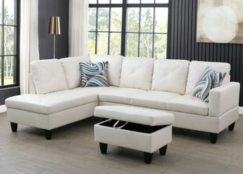 White leather sectional couch and ottoman