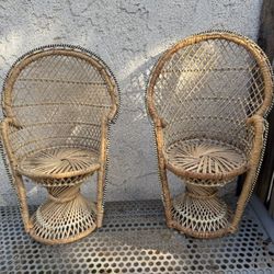 e small, doll-sized or plant stand-sized, rattan peacock chairs.