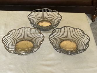 Vintage silver-plated flower-shaped wire baskets.
