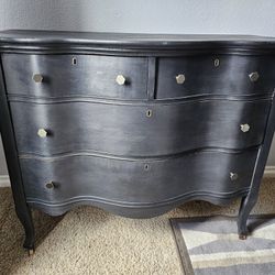 Vintage Serpentine Dresser On Wood Wheels