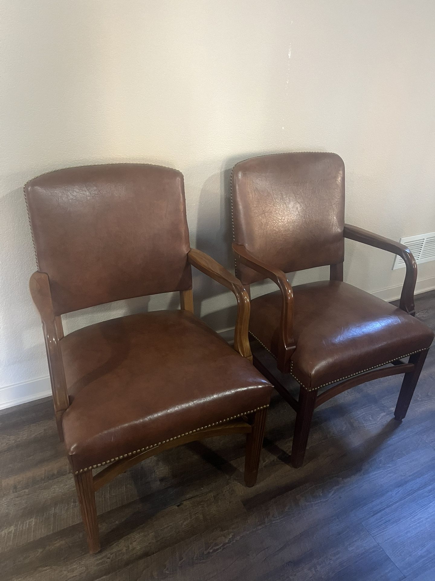 Two light brown leather chairs