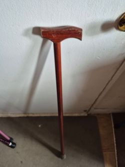 three collapsible walking canes and one solid wood cane