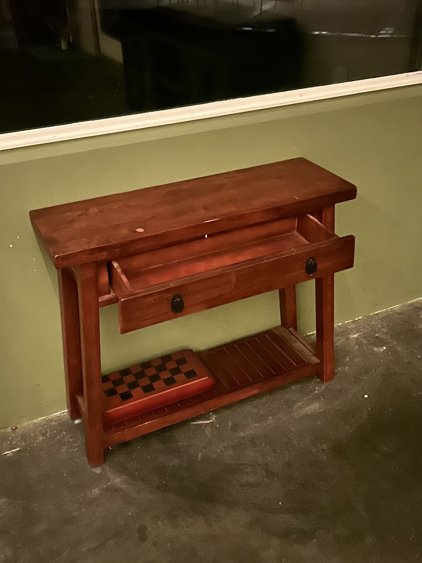 This is a solid wood console table with a drawer and lower shelf.