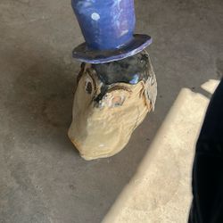 really cool old antique glass sculpture with a blue top hat 