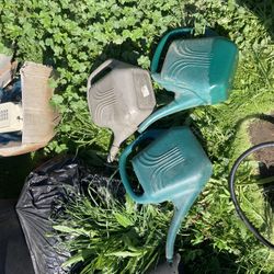 Three classic plastic gardening watering cans