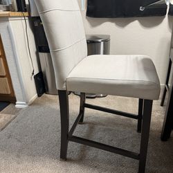 Four white soft kitchen chairs