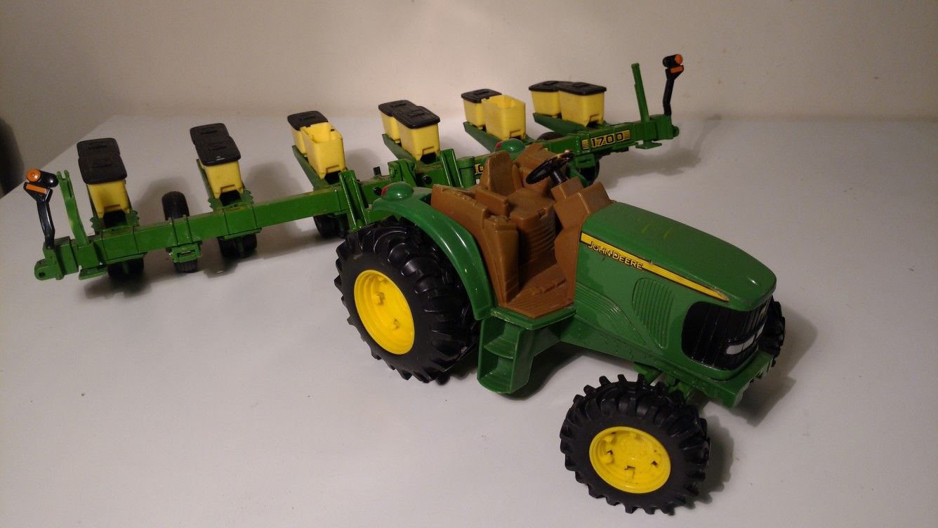 Vintage John Deere toy tractor and seed spreader set