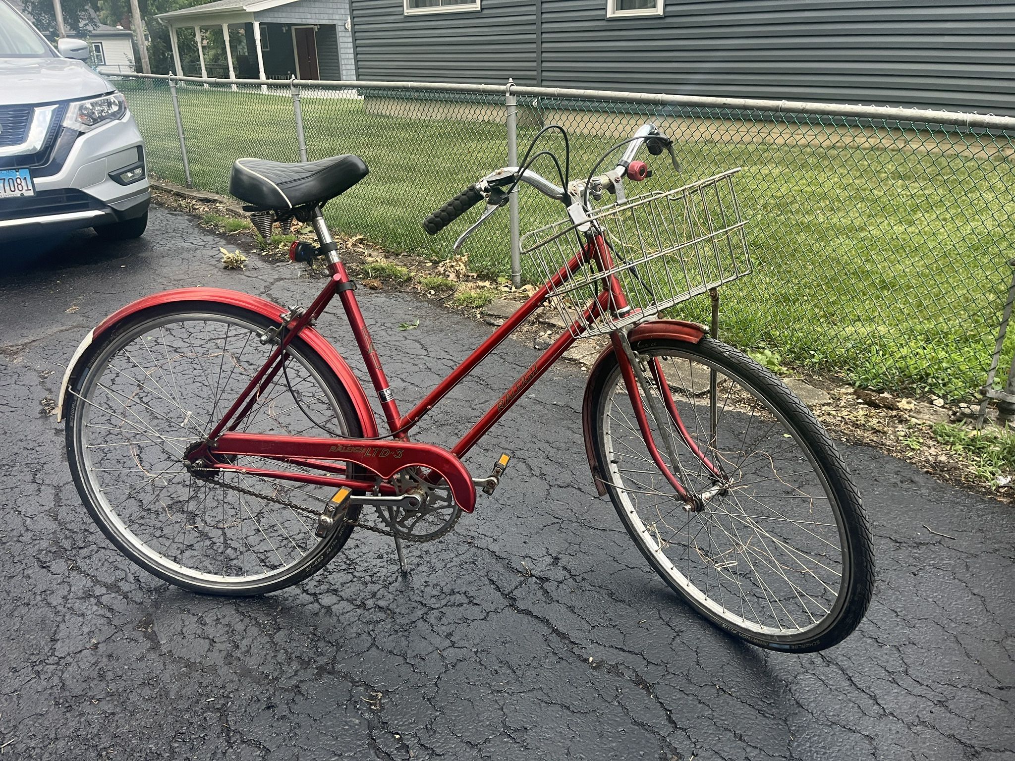 Raleigh red bike w/ basket and puncture-proof tires