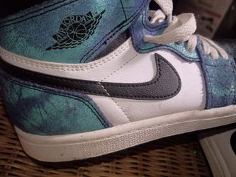 These are kids Nike Air Jordan 1 Retro High OG "Tie-Dye" sneakers in blue and green