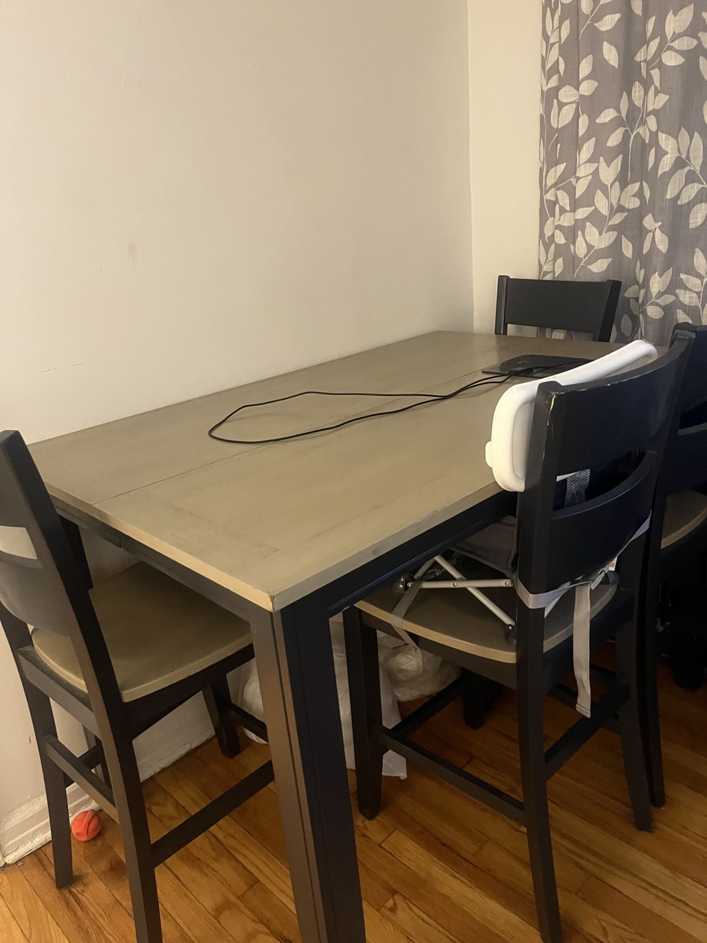 Counter high table set with a middle piece that opens up and makes the table bigger for chairs and a bench that opens the storage