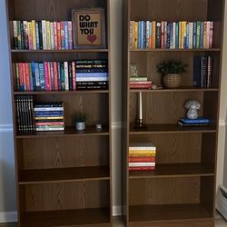 Two tall wood bookshelves 