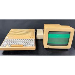 1984 Apple IIc 2c Computer, Computer Monitor and Power Supply. Came from estate, full functionality unknown. Powers on and keyboard works. Some discol