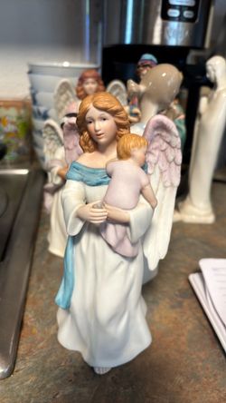 Porcelain guardian angel with child figuring