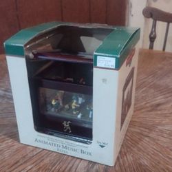 Mr. Christmas Music And Motion Animated Music Box Santa And Elves, from 1999 and measures 6" by 6" by 5"
