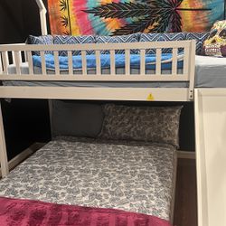 selling double bed with bunk bed on top and slide for children.