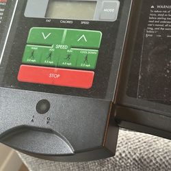 Home gym treadmill, stationary bike, and body weight machine.