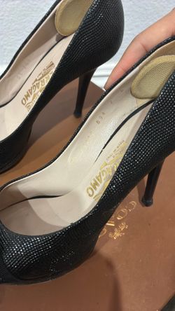 Salvatore Ferragamo Gilia pebble black peep-toe heels featuring a gold Vara bow.