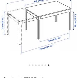 Extendable dining table in white, seats 6-8.