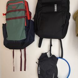 2 backpacks and a water pack