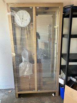 Grandfather clock with glass display curio.