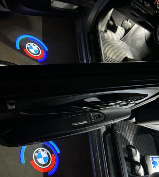 4 BMW 5OTH anniversary door logo lights. Other BMW logo lights, BMW Rim Center Caps, BMW seat belt pads, BMW emblems,BMW tire valve caps Sold Separate