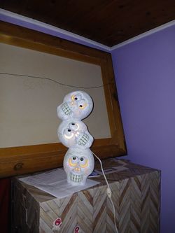 Lighted ceramic skull decor with 2 small unlighted skulls