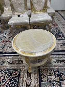 Curio Baroque Side Table LOOK UP Ornate Baroque-style round side table with gilded accents and stone top. TIME PERIOD 20th Century Revival ORIGIN Li