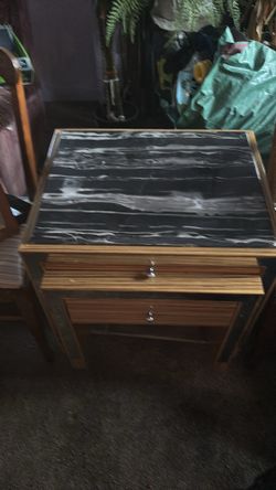Black marble table with rolling drawers
