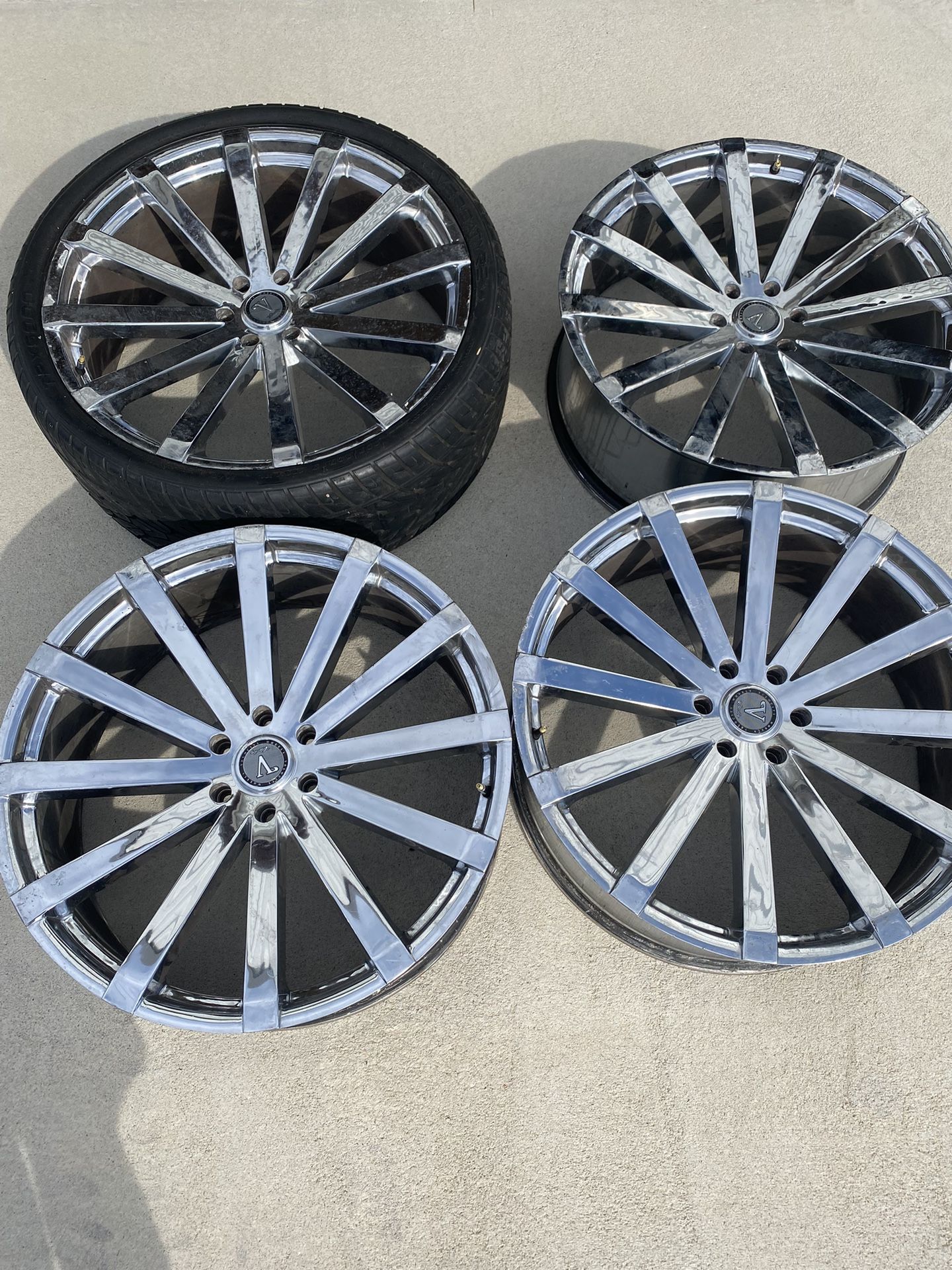 Velocity VW12B 26 x 10 chrome rims. Monster 26” truck rims with all four caps and 24 lug nuts. One has a tire on it. All are used and have some scratc