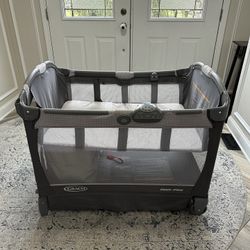 Graco Pack n Play Cuddle Cove, Includes Sound Machine, Changing Station, Mattress Protector, & sheet