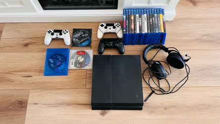 PS4 with controllers, games , and headphones