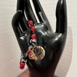 Multicolor red and black bracelet with gold accessories