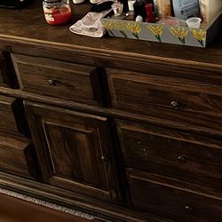 Wooden dresser with hidden drawers.