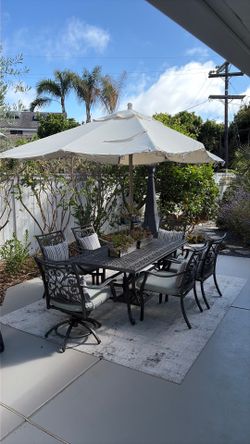Outdoor dining set with cushions, rug, umbrella, umbrella stand
