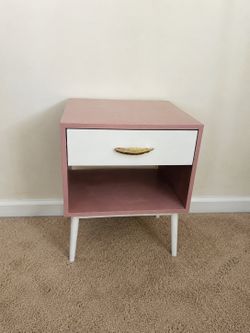 Pink and white nightstand with drawer and open storage shelf