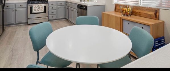 Round white table with four chairs