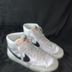 This is a Nike Blazer Mid '77 Vintage shoe with a white leather upper and black Nike