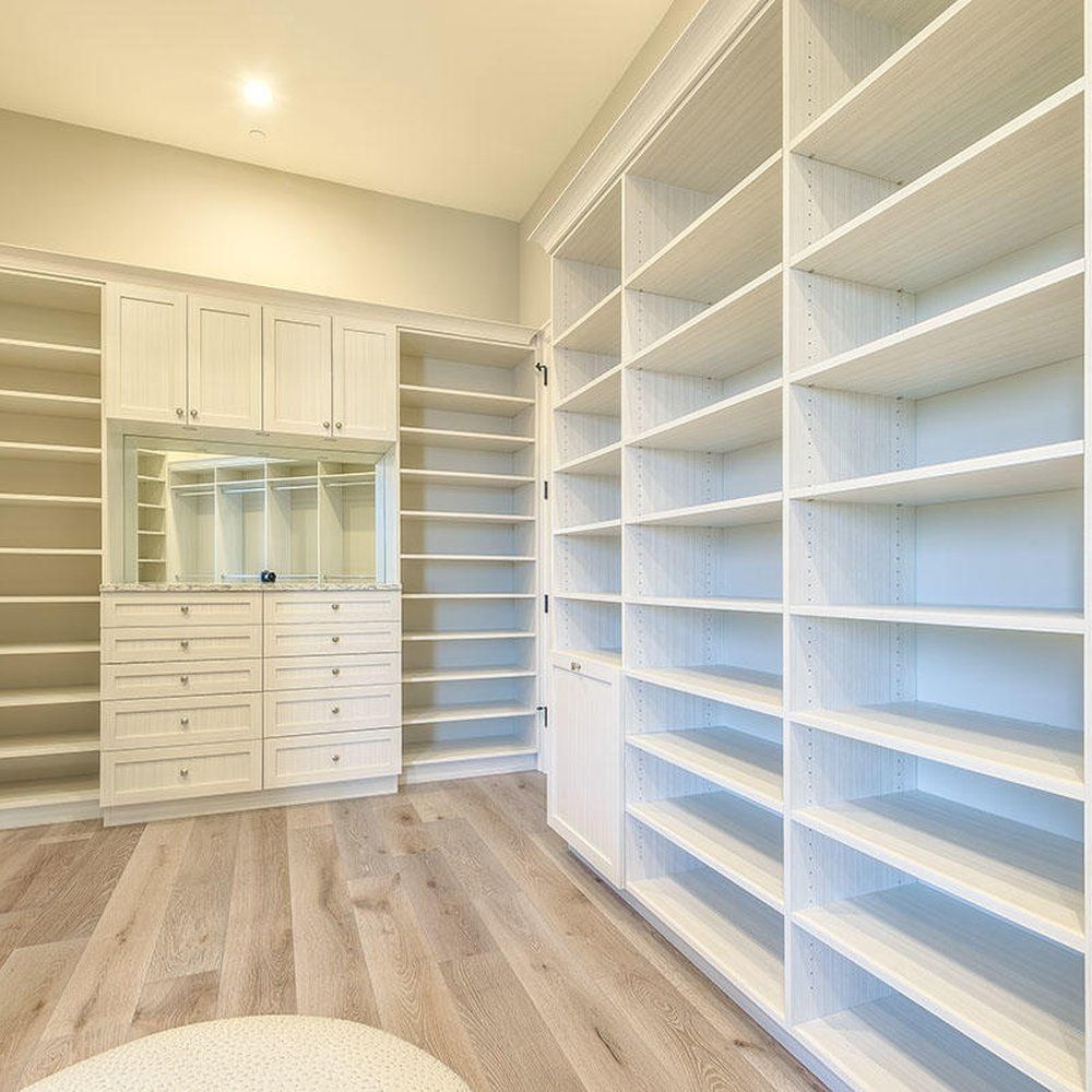 Master Walk In White Closet with Raised Drawer Front...