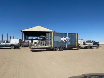 40ft container on gooseneck trailer with front stage/platform.