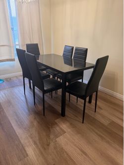 For Sale: Like-New 6-Piece Black Glass Top Dining Set - Barely Used!