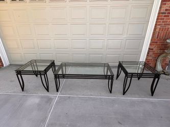 A set of 3 black frame heavy duty indoor/outdoor glass tables- good condition