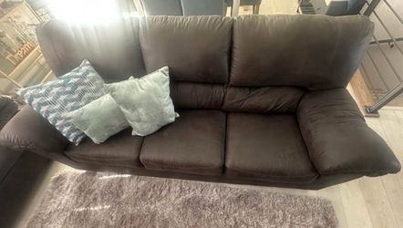 Dark Grey Sofa Ashley’s. Table, Rug, and cube floor decorative pillows included.