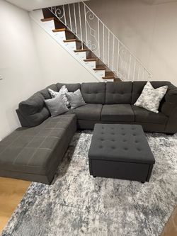 Gray sectional with storage ottoman